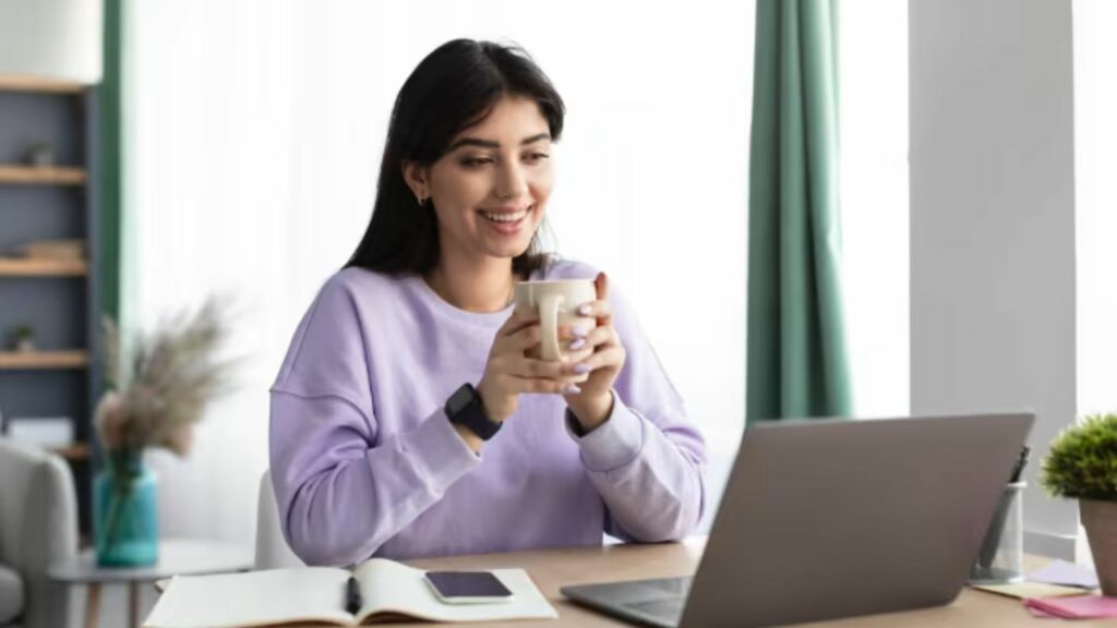  a lady on her laptop,having a cup of coffe 
